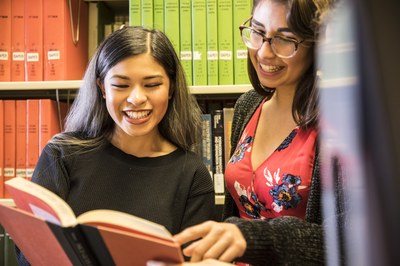 Students in Foster Business Library stacks